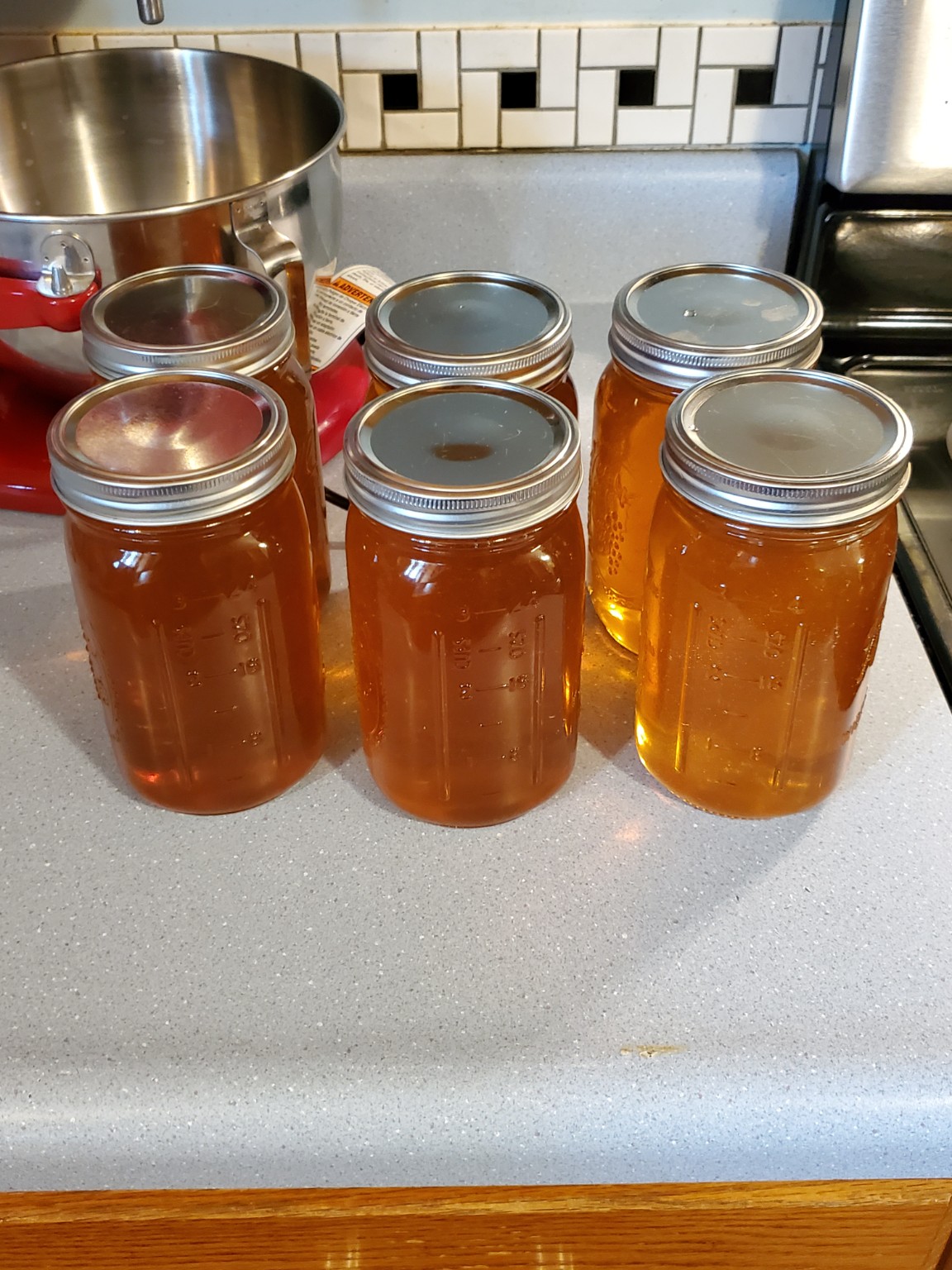 Glass jars of golden honey from a past 4J harvest